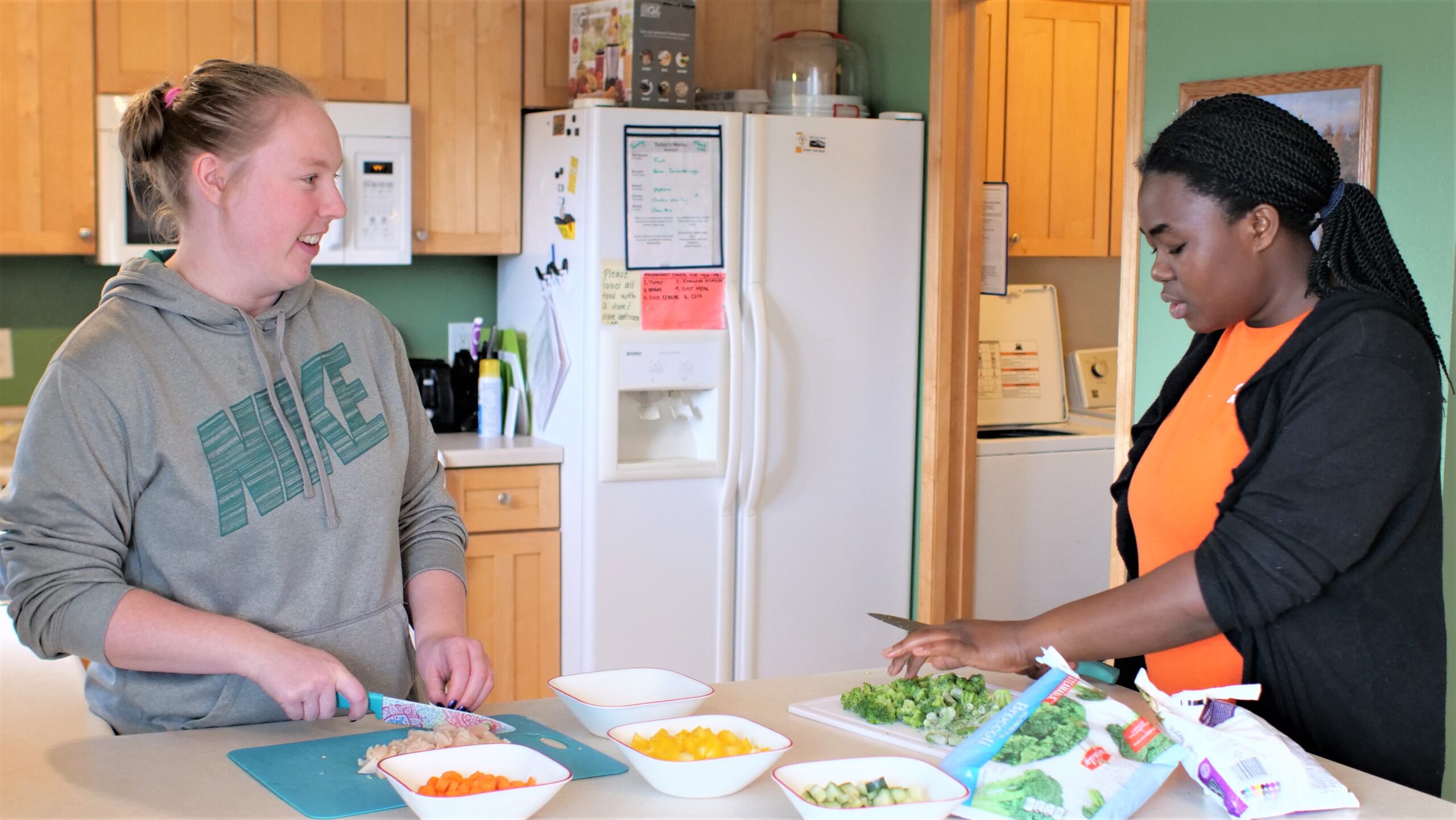 Residents preparing a meal together in the kitchen